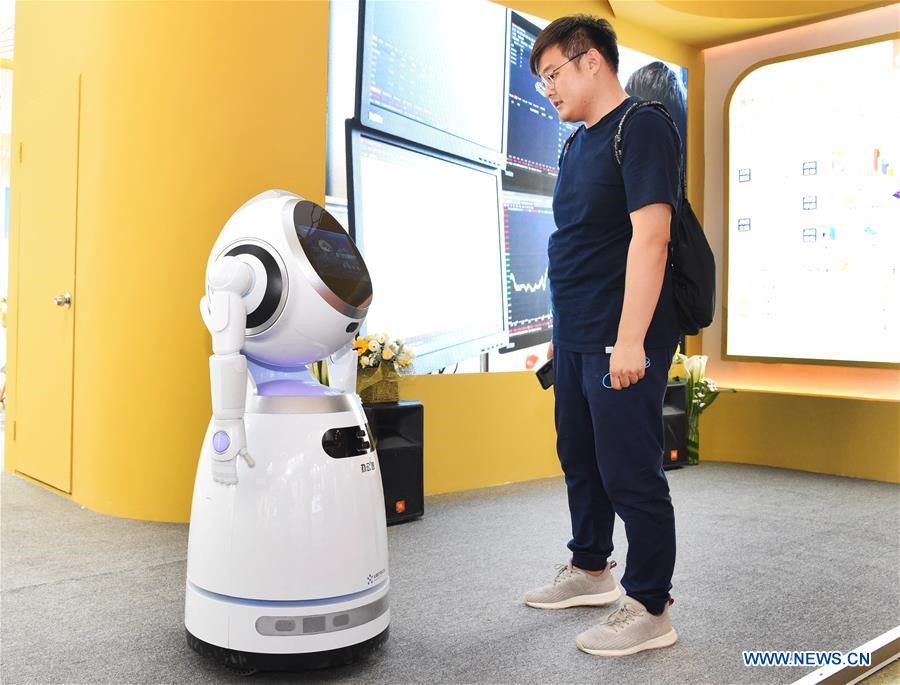 A visitor interacts with a robot 